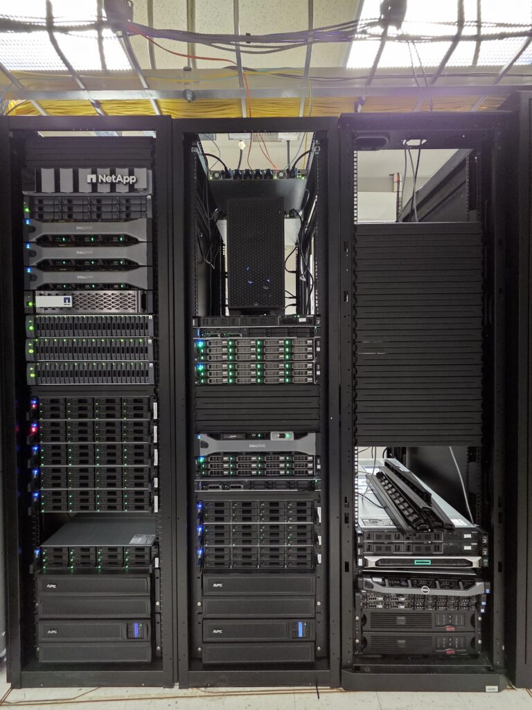Close-up of network cables and ports in a server rack, showcasing connectivity.