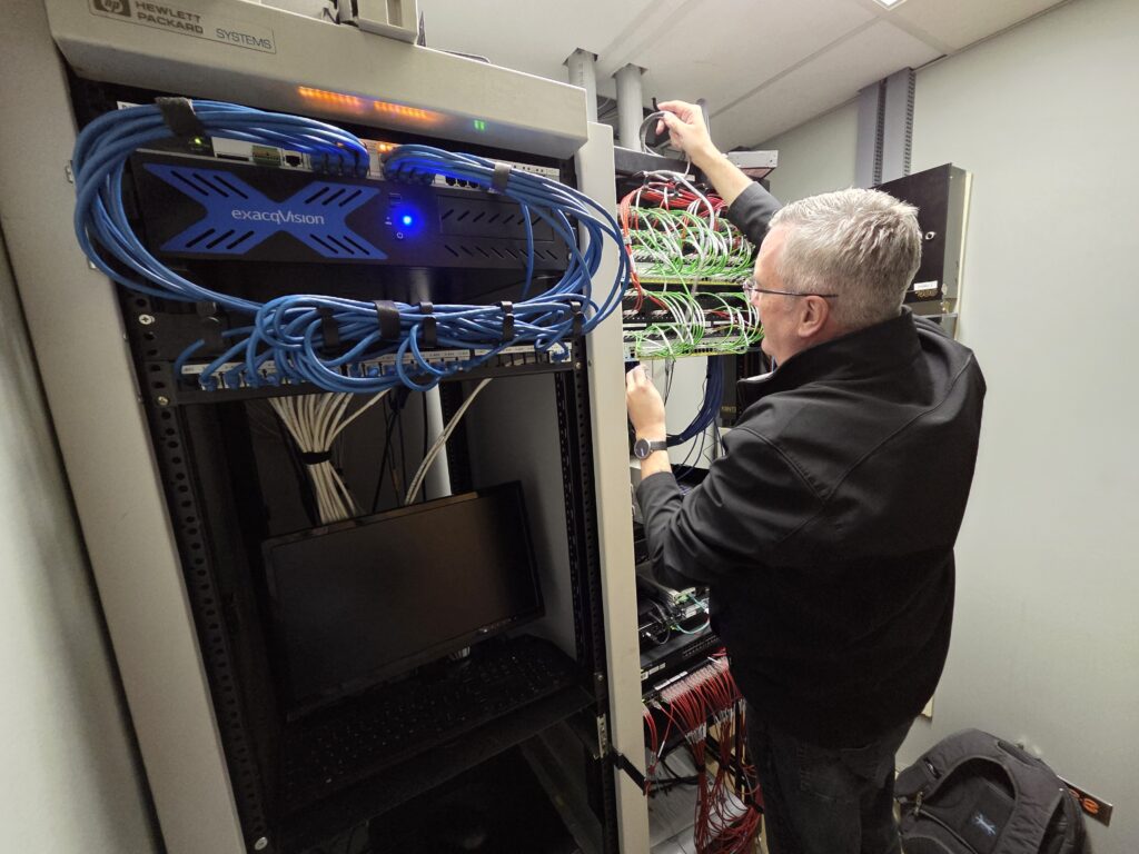 IT professional completing maintenance on a server rack